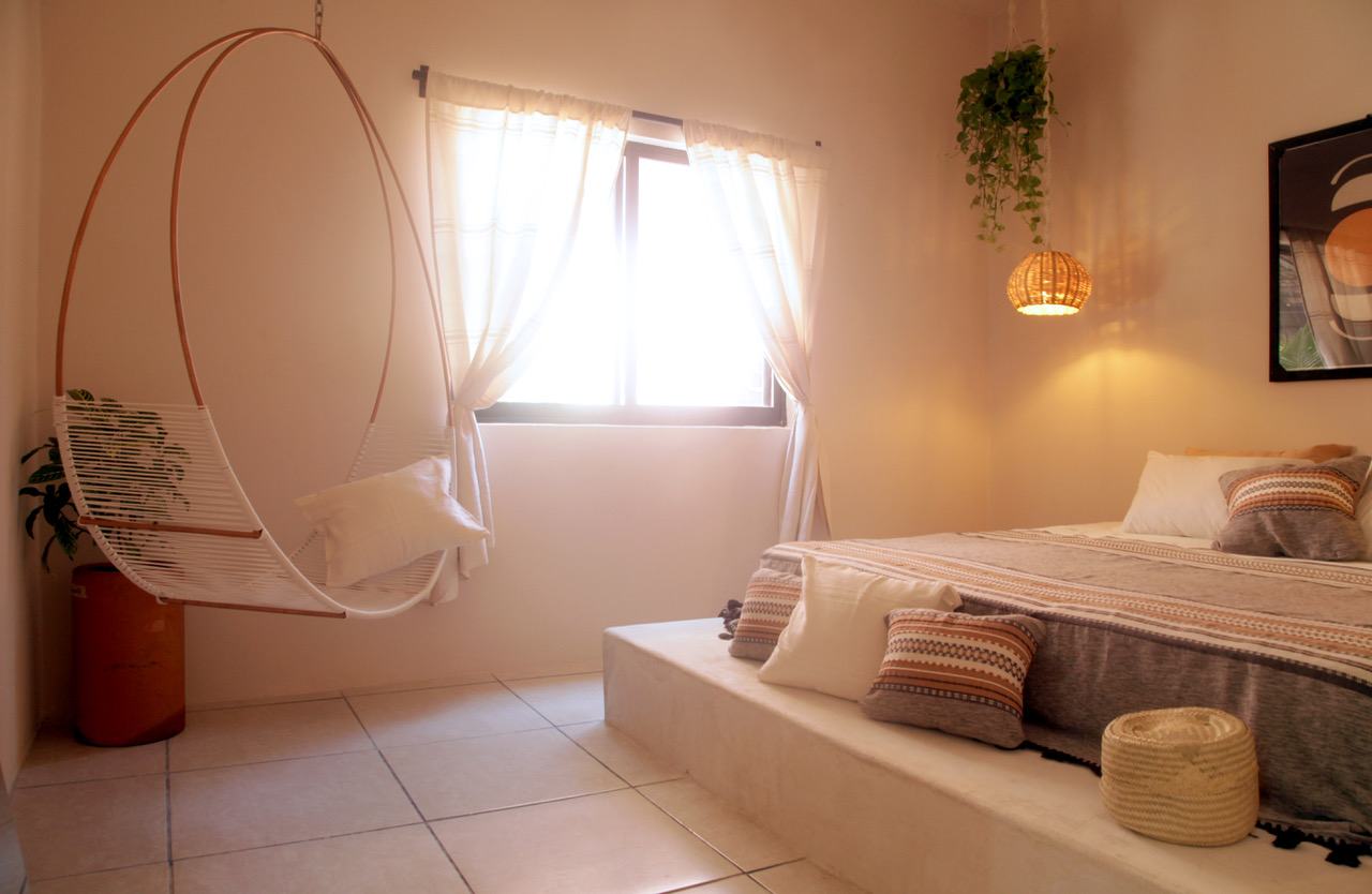 Apartment bedroom with a hanging chair by the window