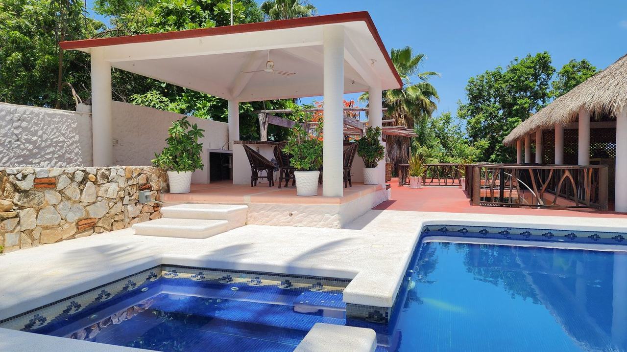 The pool and the jacuzzi, with the white pavilion behind