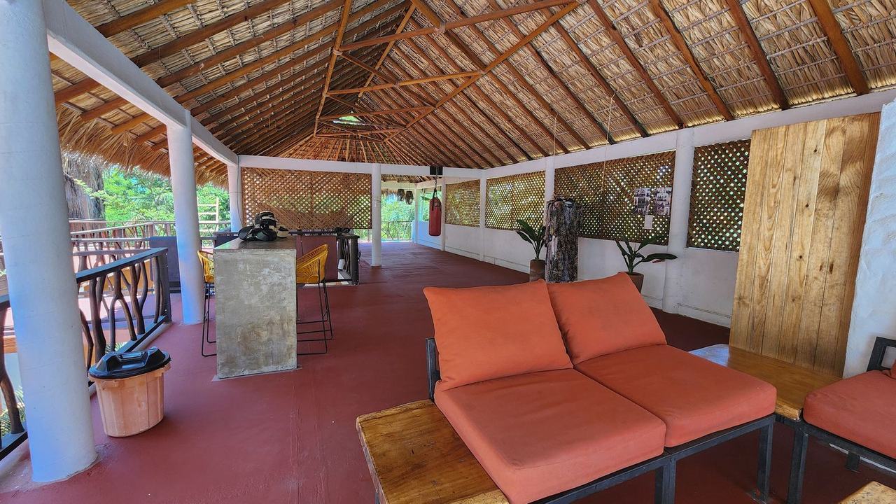 Covered lounge and bar table under the palapa roof