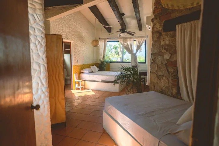 Room in the main house with stone wall and garden window